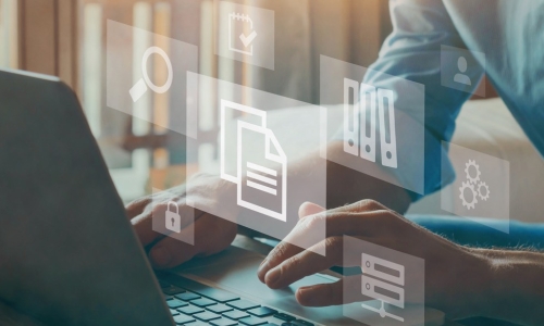 businessman with laptop and floating images