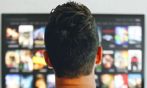 man watches his connected TV with many show choices