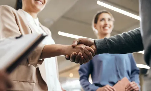manager shaking hands and greeting new hires at the office