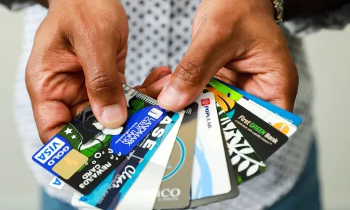 Josh Hatcher of Vericast displaying fanned out selection of customized payments cards