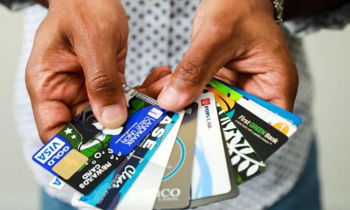 Josh Hatcher of Vericast displaying fanned out selection of customized payments cards