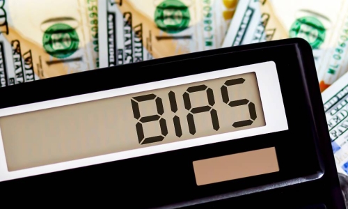 calculator with bias on screen atop money