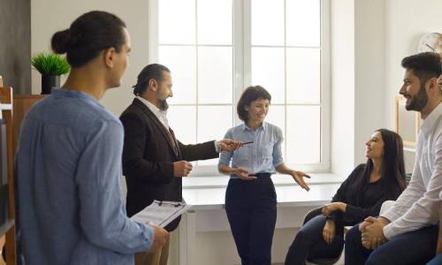 Group of coworkers listening as one tells a story