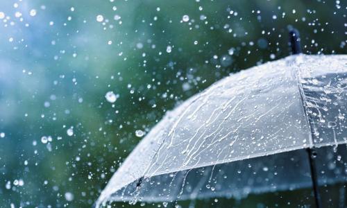 transparent umbrella splattered by heavy rain drops