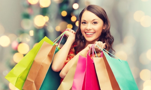 woman doing holiday shopping with colorful bags