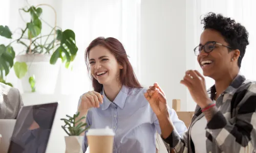 young-employees-laughing-coffee-table