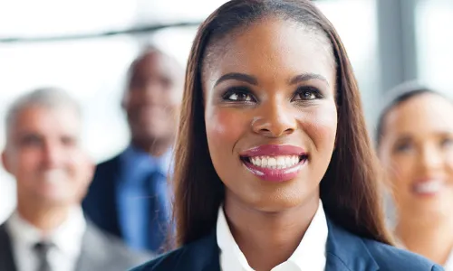 new board member smiling and standing in front of other directors
