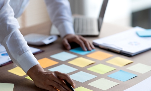 post it notes laid out on desk preparing for meeting