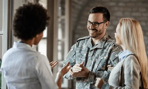 Couple speaking to a woman
