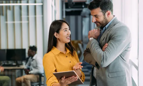 man and woman talking in office