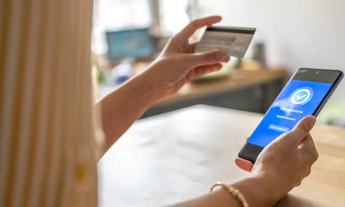 online shopping - hand holding credit card and cell phone